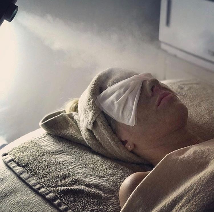 A steamer is used by a holistic esthetician during natural facial treatments with holistic skin care to enhance how skin care products absorb